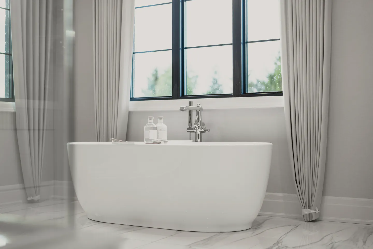 A white freestanding bath and its floor mixer