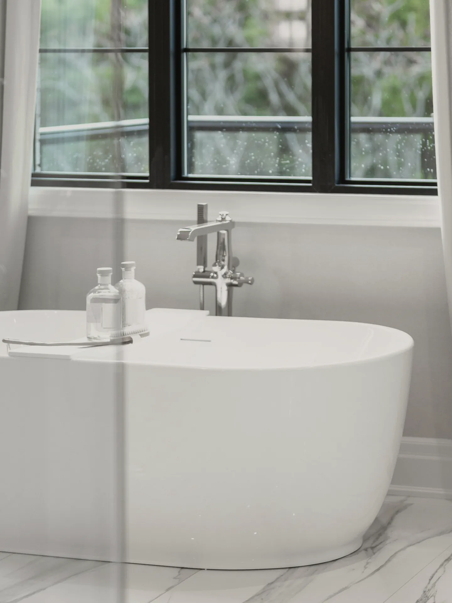 The floor mixer beside the freestanding bath