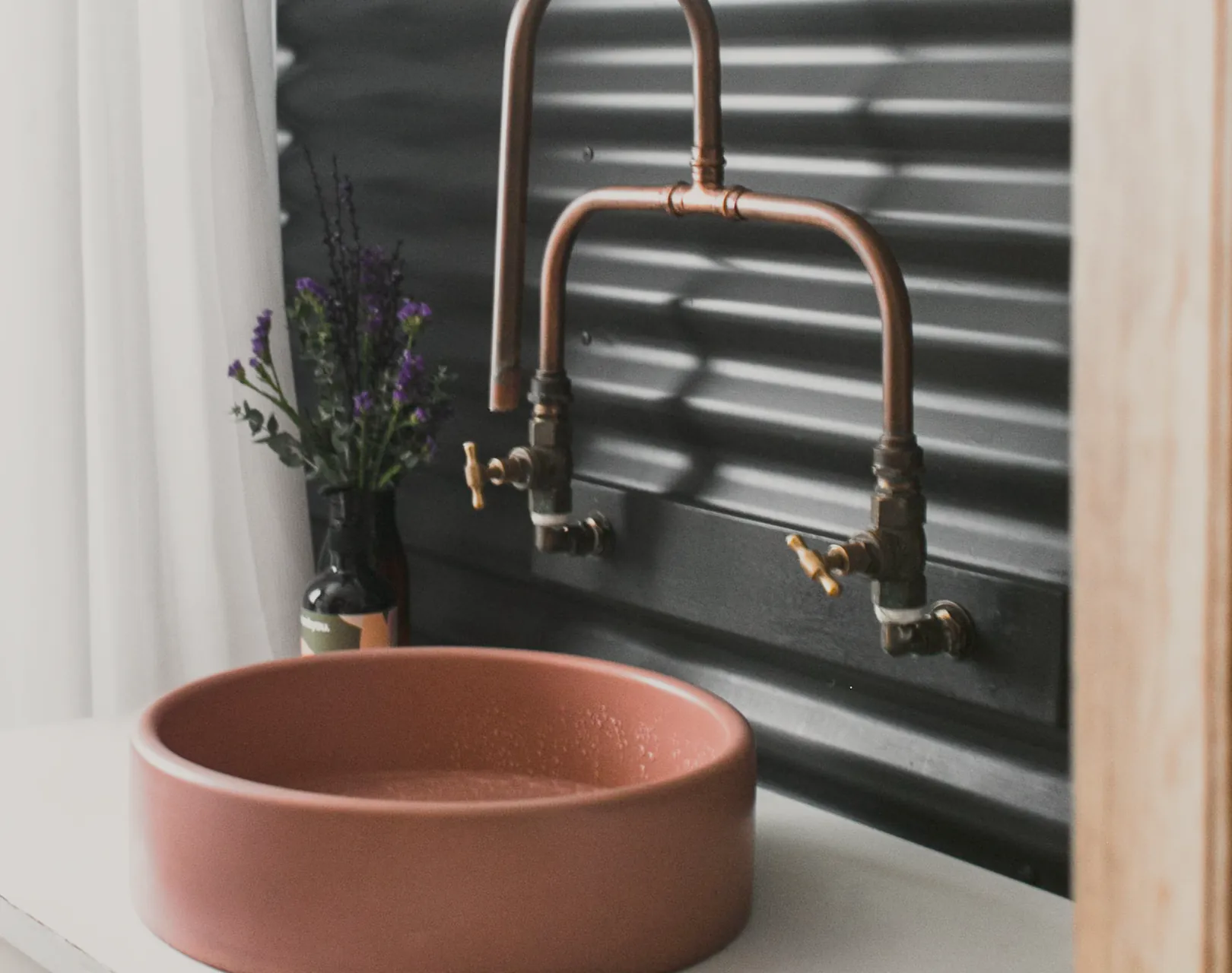 Copper wall taps over a terracotta basin