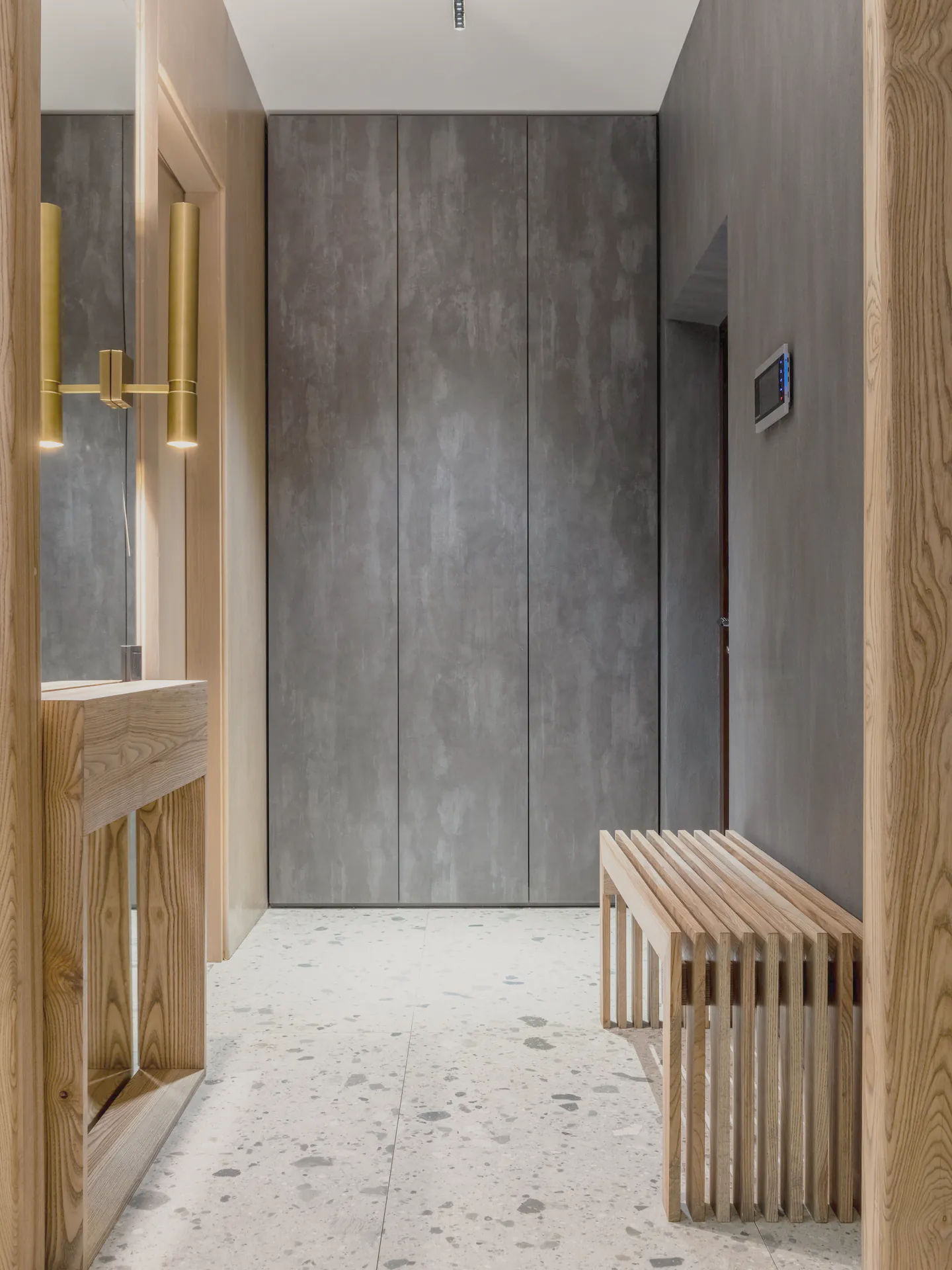 Oak and dark walls over the terrazzo floor in the next room