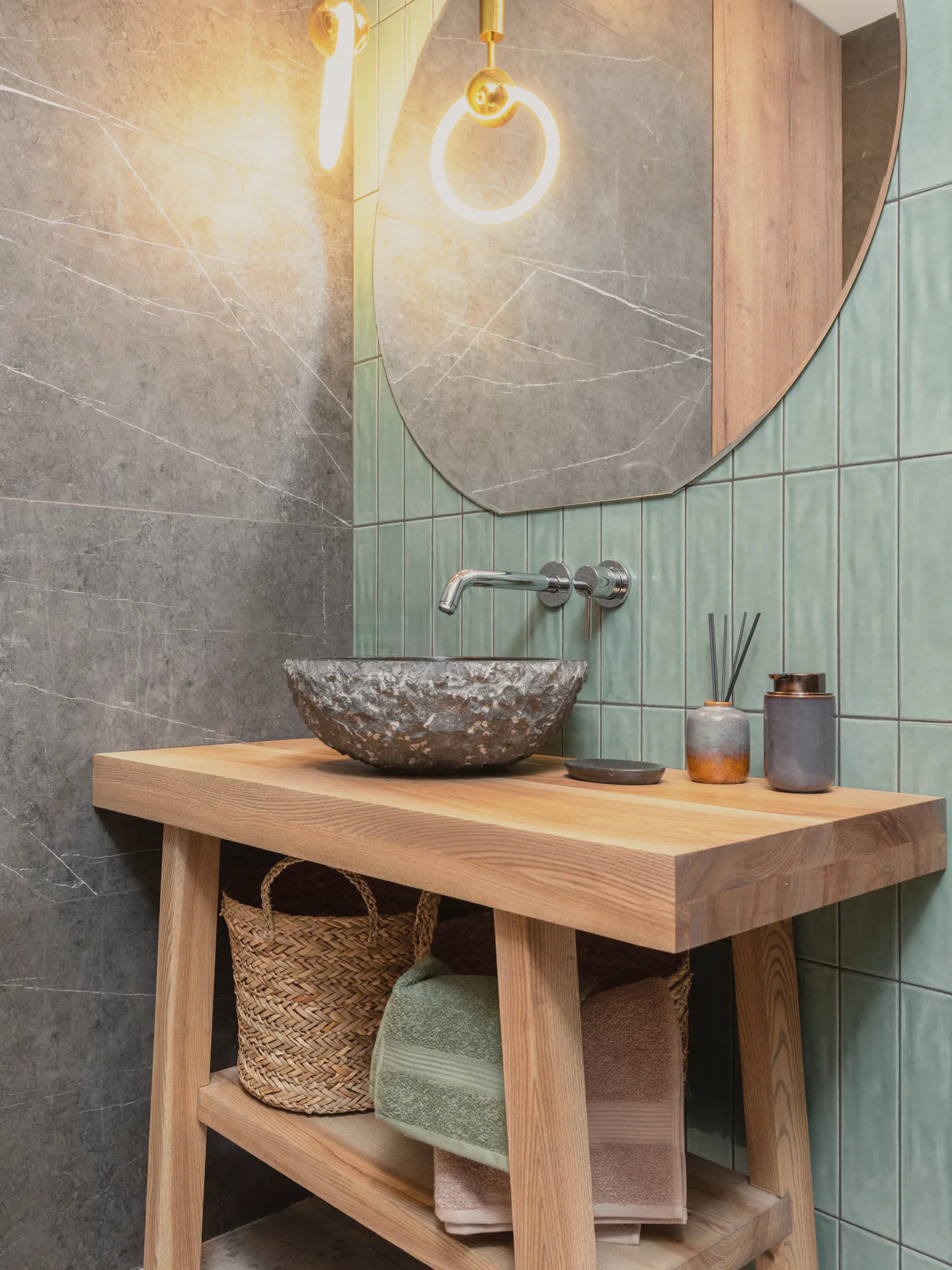 The bathroom’s green tile and terrazzo floor