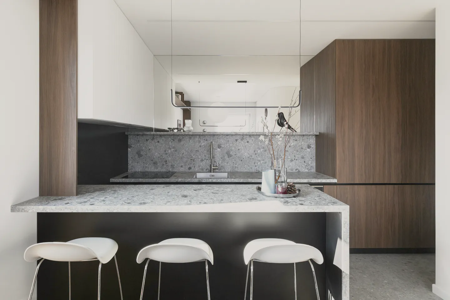 Walnut cabinets and speckled benches