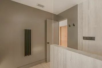 The ensuite’s dark walls and towel rail