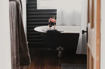 The clawfoot bath through the bathroom door