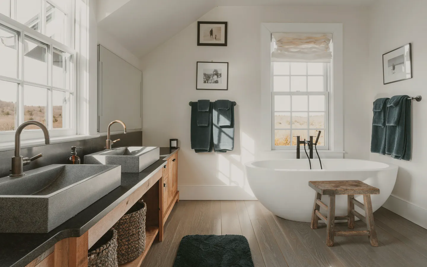 A finished bathroom with a freestanding bath under a window