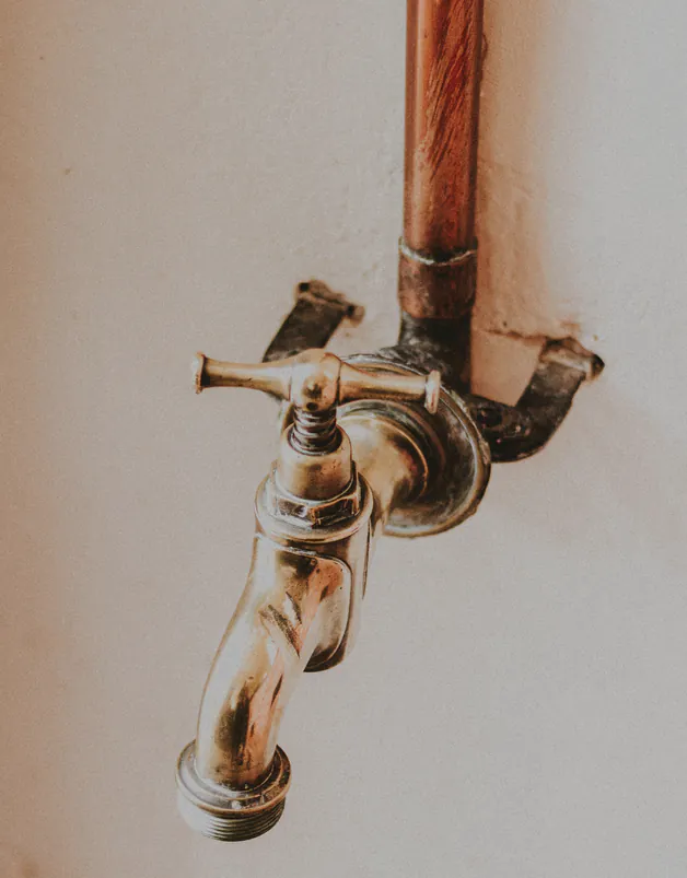 An old brass mixer with cross handles