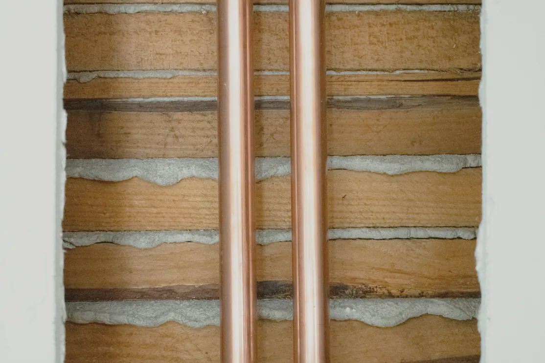 Copper risers chased into a brick wall before lining