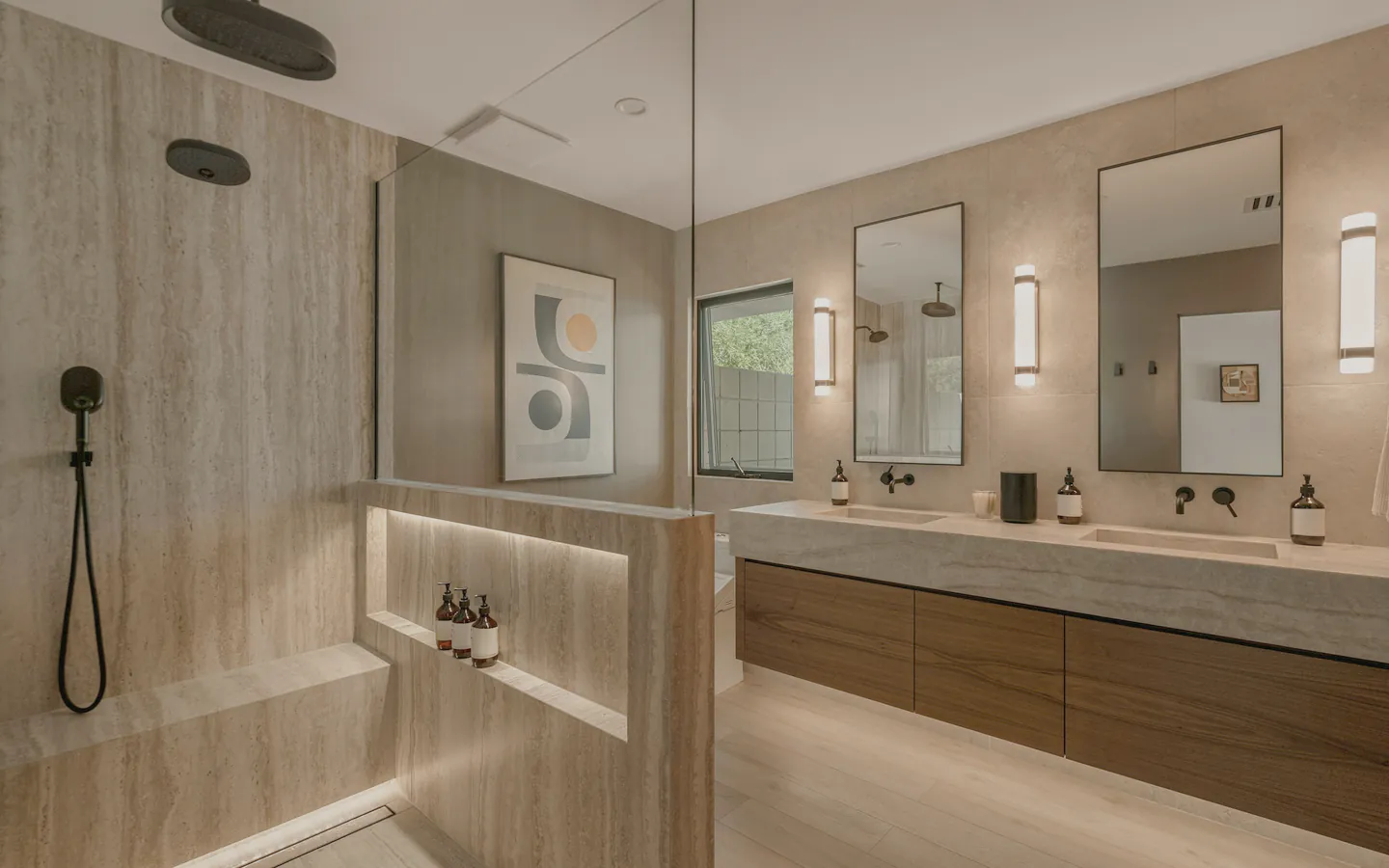 A travertine ensuite with a double vanity and a walk in shower