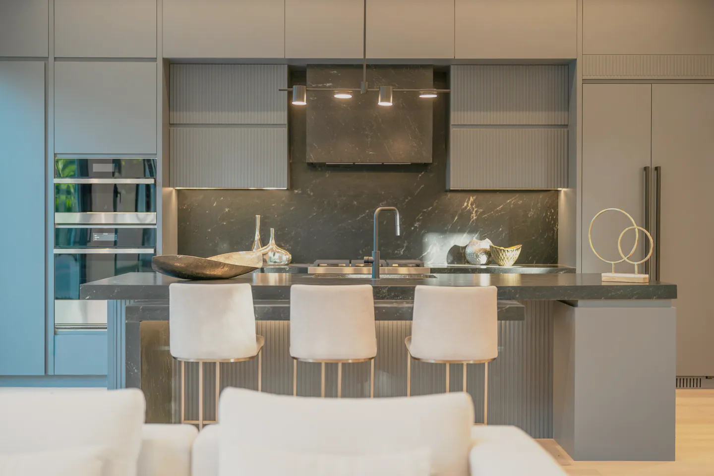 A kitchen in dark grey cabinetry