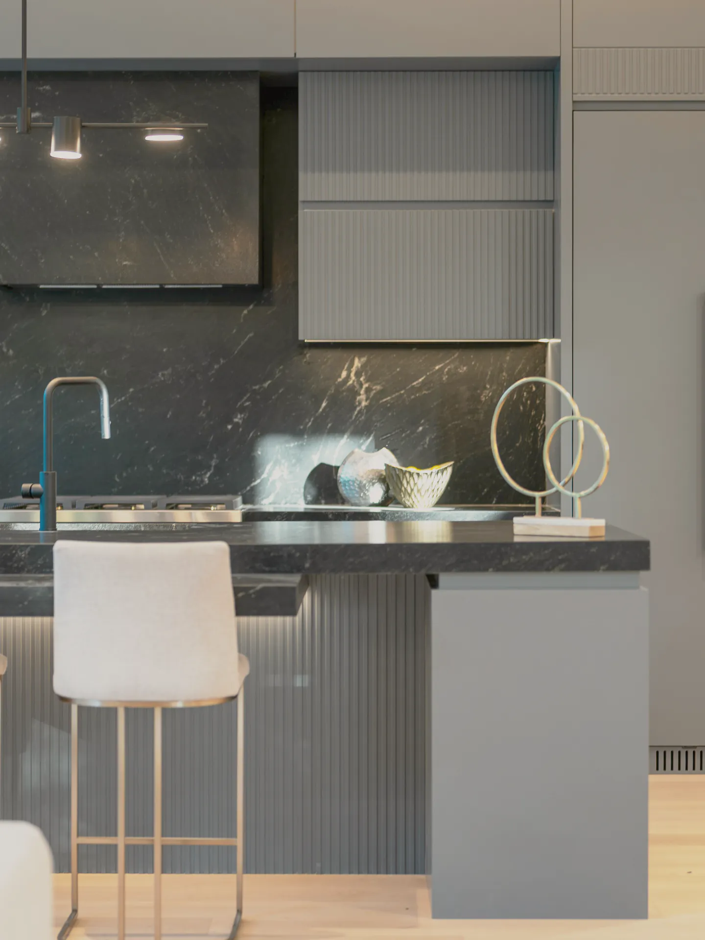 The kitchen’s dark marble benches